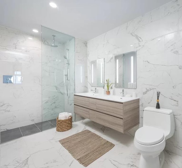 bathroom with a marble finish shower, toilet, and stone wall