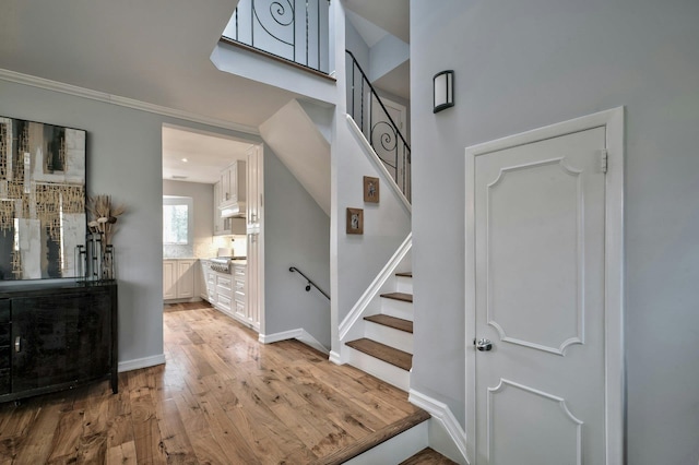 stairs with wood-type flooring and baseboards