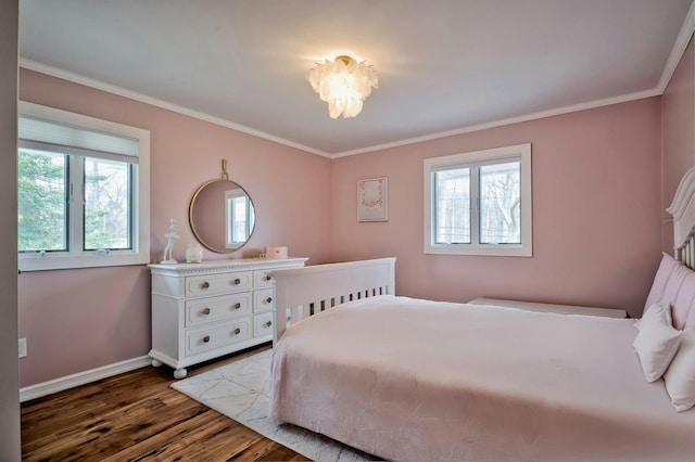 bedroom with dark wood-style floors, crown molding, and baseboards