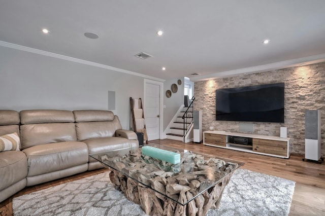 living room featuring stairs, ornamental molding, wood finished floors, and visible vents