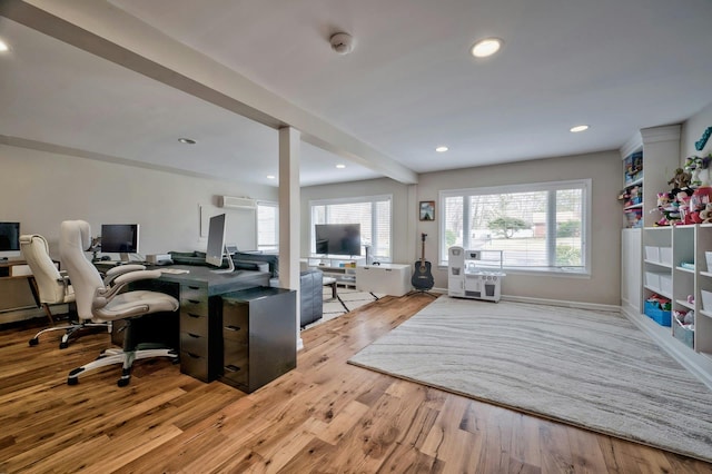 office space featuring light wood-style floors, beamed ceiling, a wealth of natural light, and recessed lighting