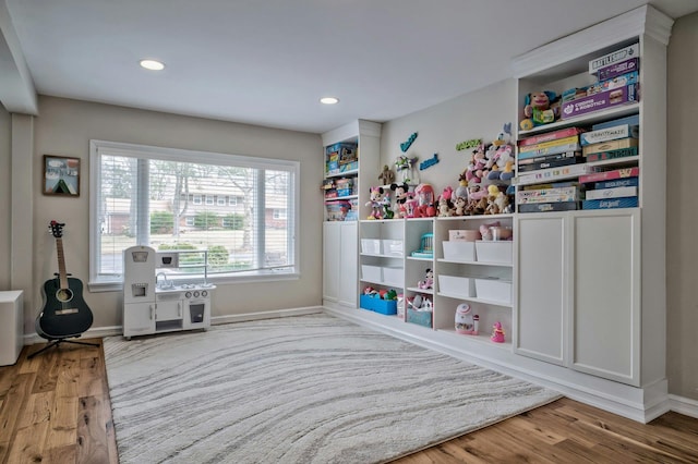 rec room featuring recessed lighting, baseboards, and wood finished floors