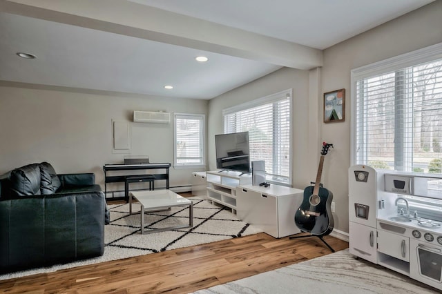 living area featuring baseboards, wood finished floors, a wall mounted air conditioner, a baseboard heating unit, and recessed lighting