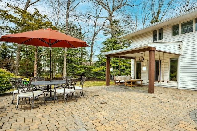 view of patio featuring outdoor dining area and fence