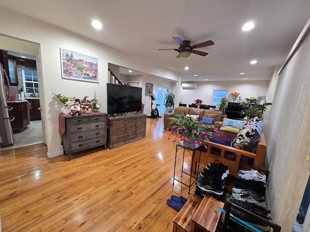 living room featuring recessed lighting, a wall mounted air conditioner, ceiling fan, and light wood finished floors