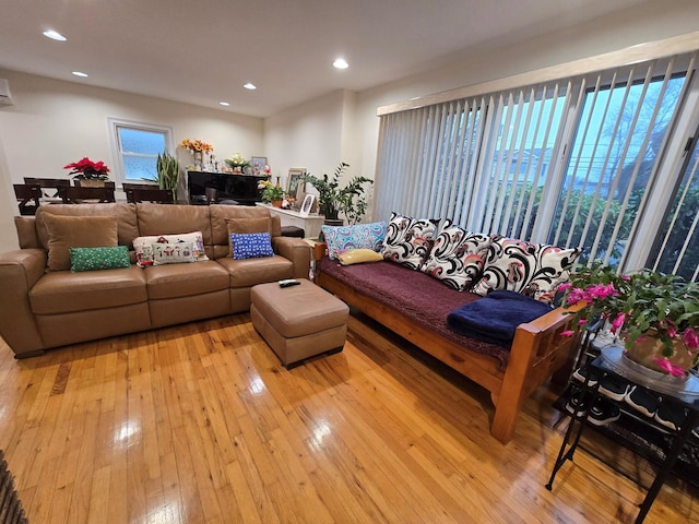 living room with light wood-style floors and recessed lighting