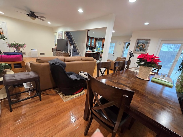 dining room with visible vents, ceiling fan, stairway, light wood-type flooring, and recessed lighting