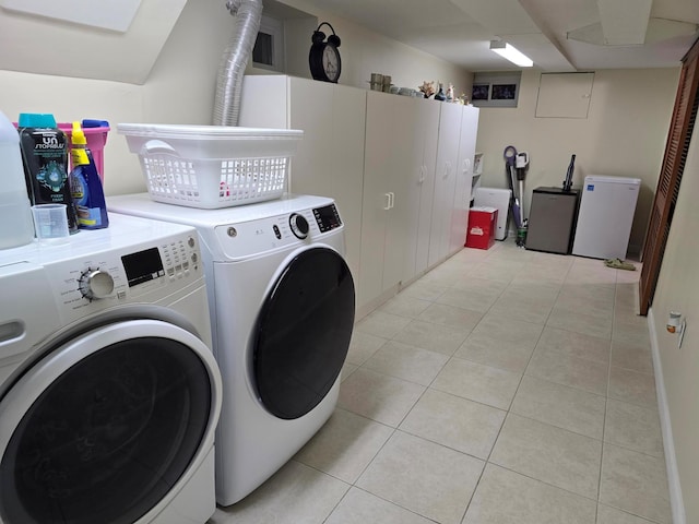 laundry room with light tile patterned floors, laundry area, and washing machine and clothes dryer