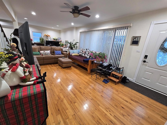 living room featuring a ceiling fan, plenty of natural light, light wood-style flooring, and recessed lighting