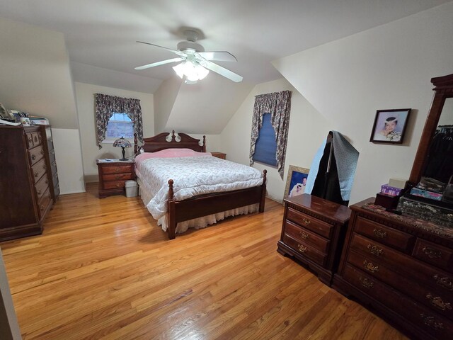 bedroom featuring light wood-type flooring, a ceiling fan, and lofted ceiling