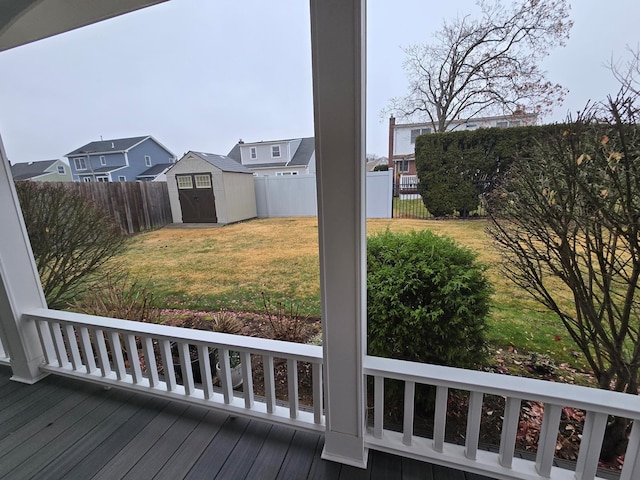 view of yard featuring a storage unit, an outdoor structure, and a fenced backyard