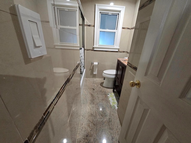 bathroom featuring granite finish floor, vanity, and toilet