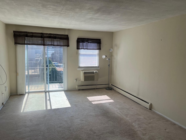 carpeted empty room with a baseboard radiator, a textured ceiling, and a wall unit AC