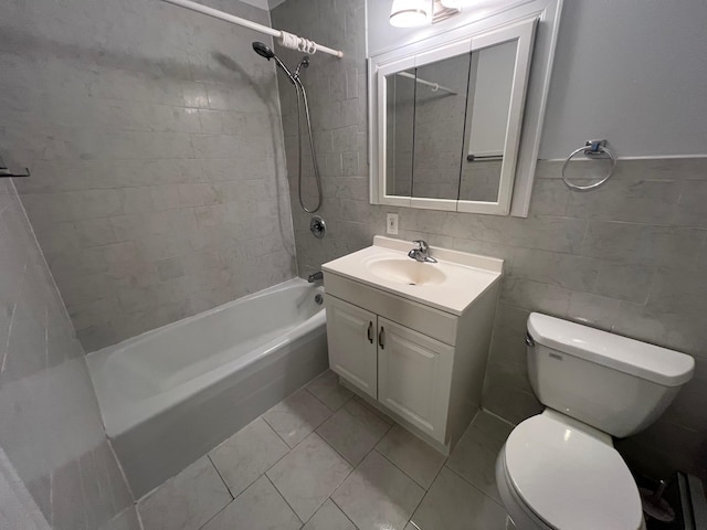 full bathroom featuring tile walls, vanity, toilet, and shower / bathing tub combination