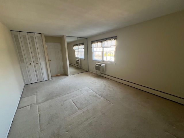 unfurnished bedroom featuring a baseboard radiator, two closets, and a wall unit AC