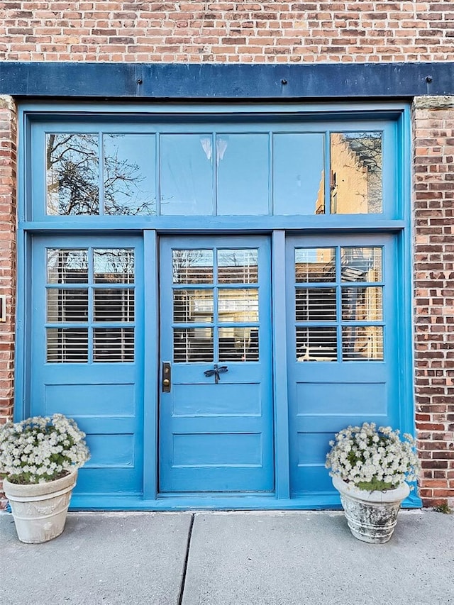 property entrance with brick siding