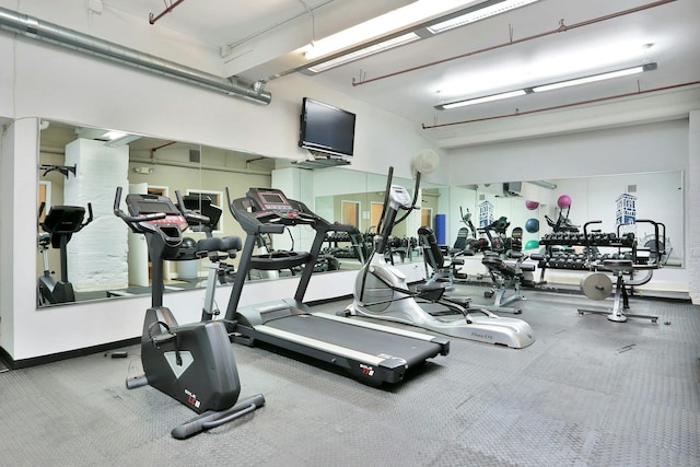 exercise room with baseboards