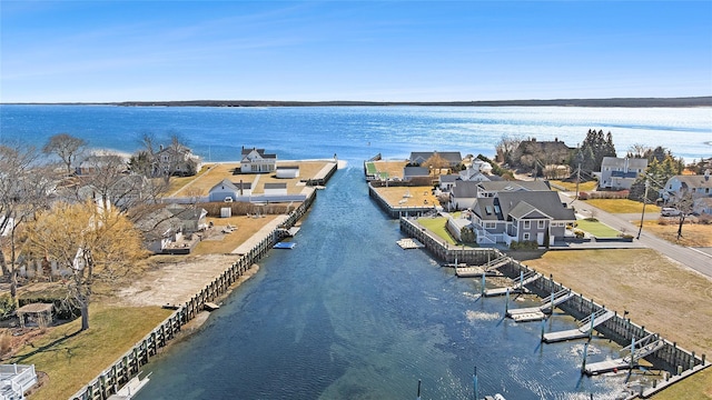 drone / aerial view featuring a residential view and a water view