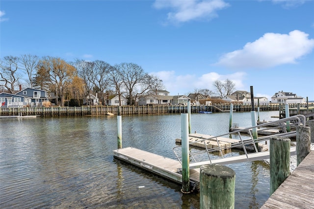 dock area featuring a residential view and a water view