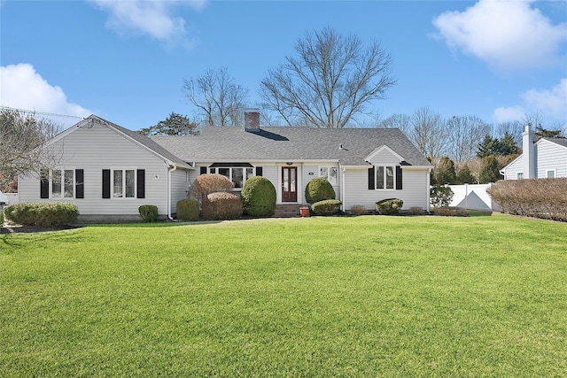 view of front of property featuring roof with shingles, a chimney, a front yard, and fence