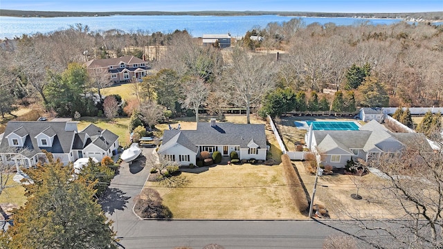 drone / aerial view with a water view and a residential view