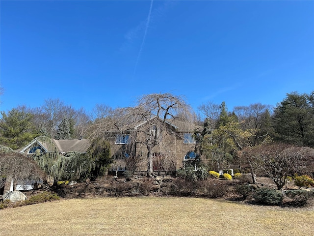 view of property exterior featuring a lawn