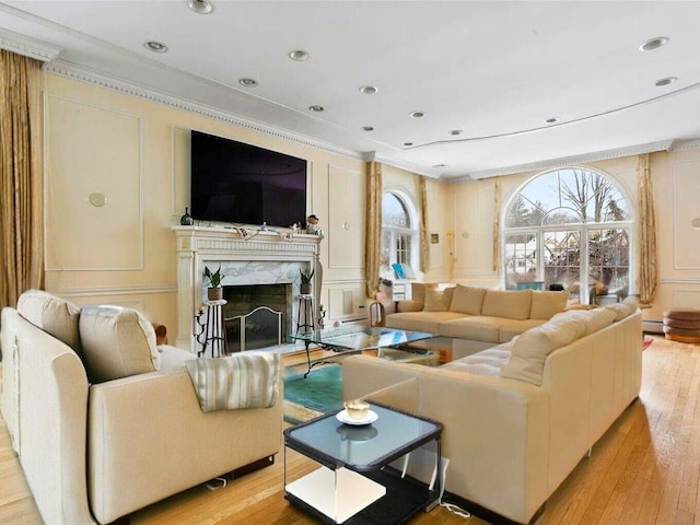 25 Pine Glen Dr, Blauvelt, NY 10913 - living area with a fireplace, a decorative wall, crown molding, and light wood-style flooring