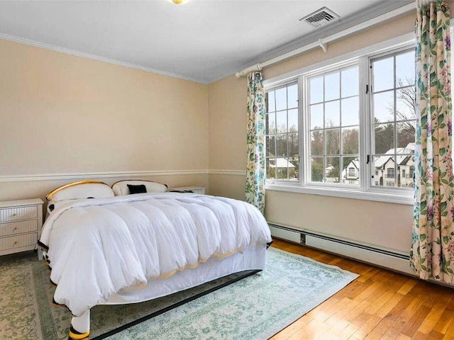 25 Pine Glen Dr, Blauvelt, NY 10913 - bedroom with ornamental molding, visible vents, baseboard heating, and wood-type flooring