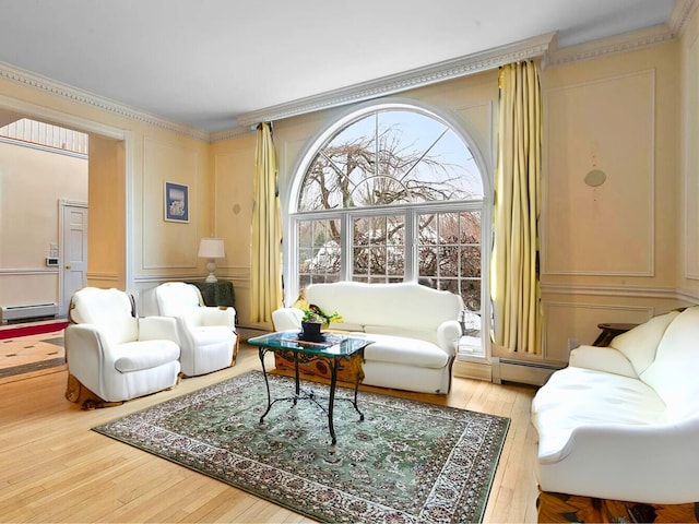 25 Pine Glen Dr, Blauvelt, NY 10913 - living room with a baseboard heating unit, wood-type flooring, ornamental molding, a baseboard radiator, and a decorative wall