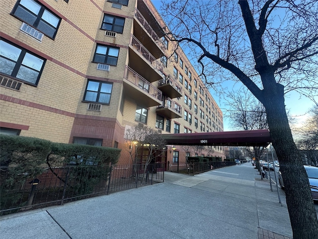 view of building exterior with fence