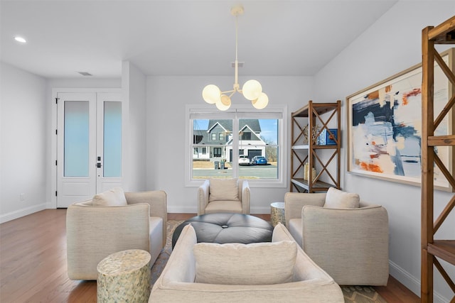 dining room featuring a notable chandelier, baseboards, and wood finished floors