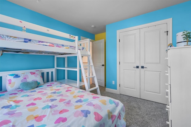 bedroom featuring a closet, baseboards, and carpet