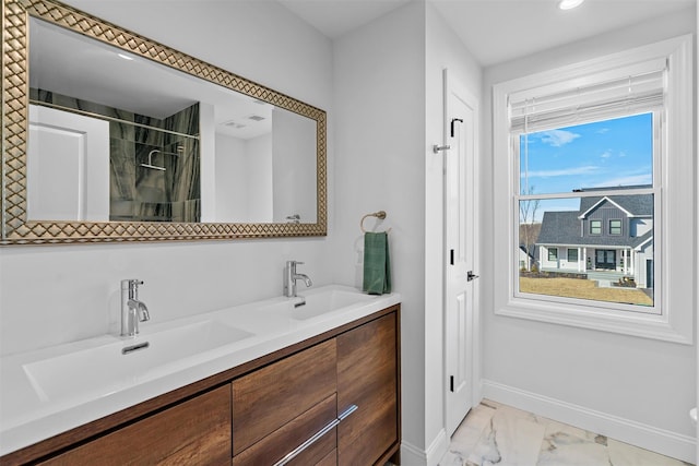 full bath with marble finish floor, a shower, baseboards, and a sink