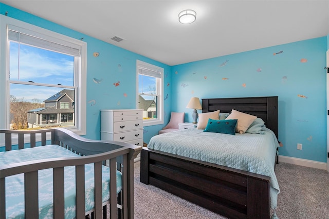 bedroom featuring visible vents, carpet flooring, baseboards, and multiple windows