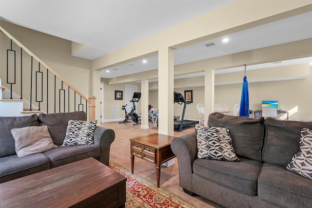 living room with visible vents, recessed lighting, stairs, and light wood-style floors