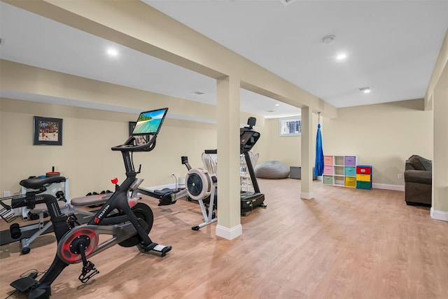 exercise room with recessed lighting, baseboards, and wood finished floors