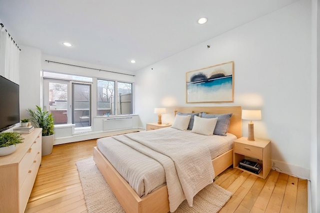 bedroom with baseboards, light wood finished floors, and recessed lighting