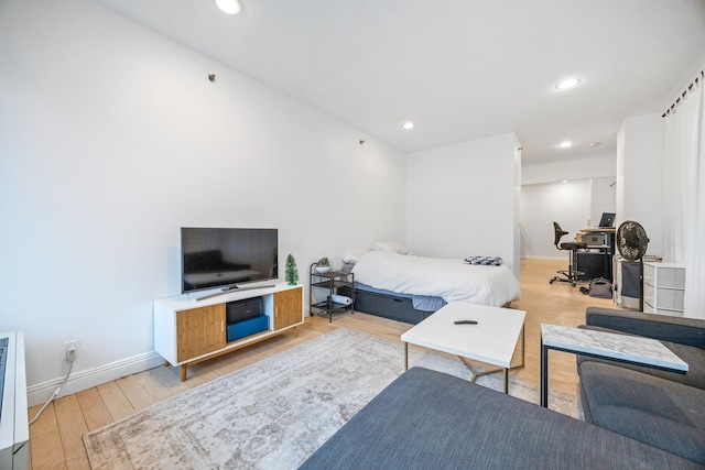 bedroom with recessed lighting, light wood-type flooring, and baseboards