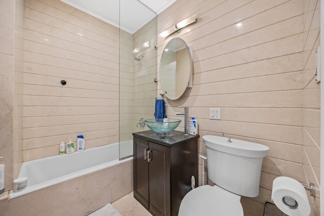 bathroom featuring ornamental molding, tiled shower / bath combo, vanity, and toilet