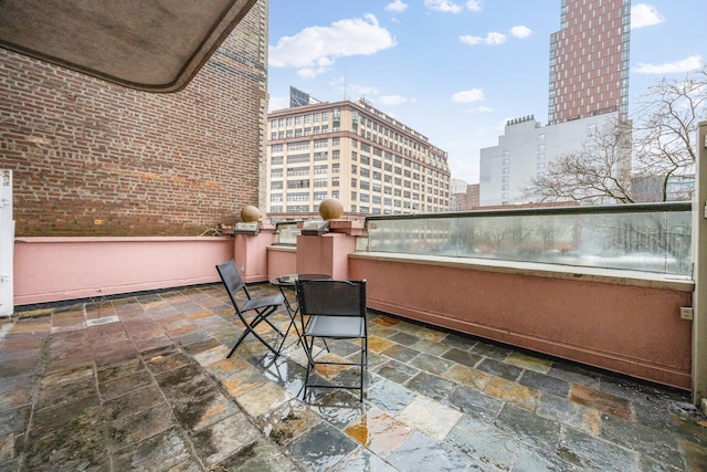 balcony featuring a patio area, a view of city, and exterior kitchen