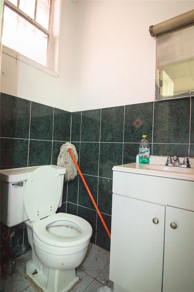 10634 Sutphin Blvd, Jamaica, NY 11435 - half bath with toilet, tile walls, vanity, and a wainscoted wall
