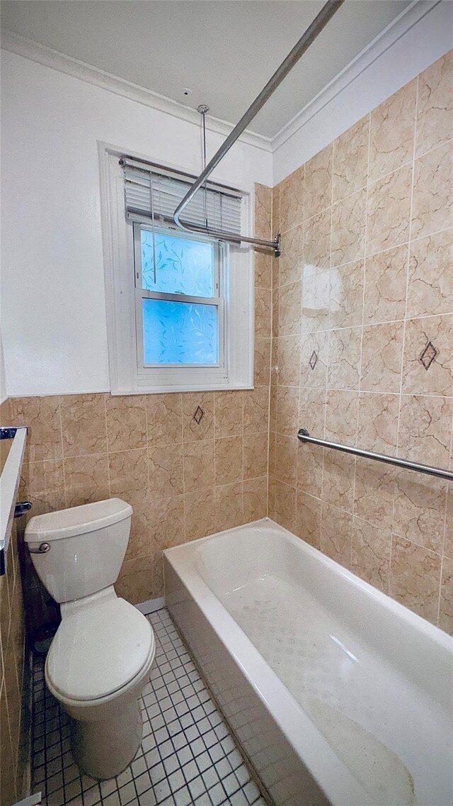 10634 Sutphin Blvd, Jamaica, NY 11435 - full bathroom featuring tile walls, toilet, crown molding, tile patterned floors, and bathing tub / shower combination