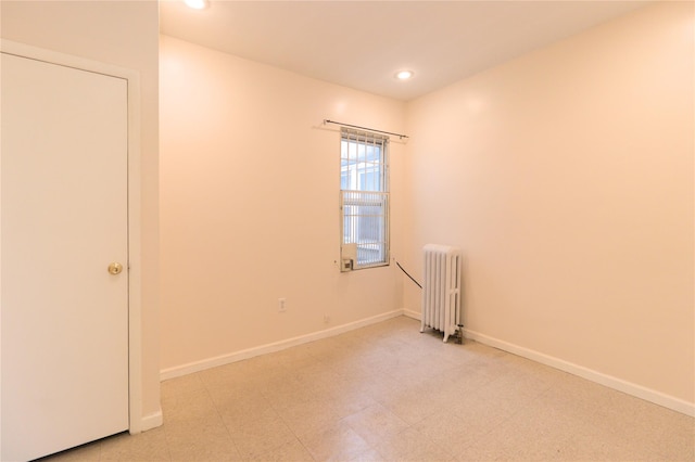 10634 Sutphin Blvd, Jamaica, NY 11435 - empty room with baseboards, recessed lighting, radiator, and light floors