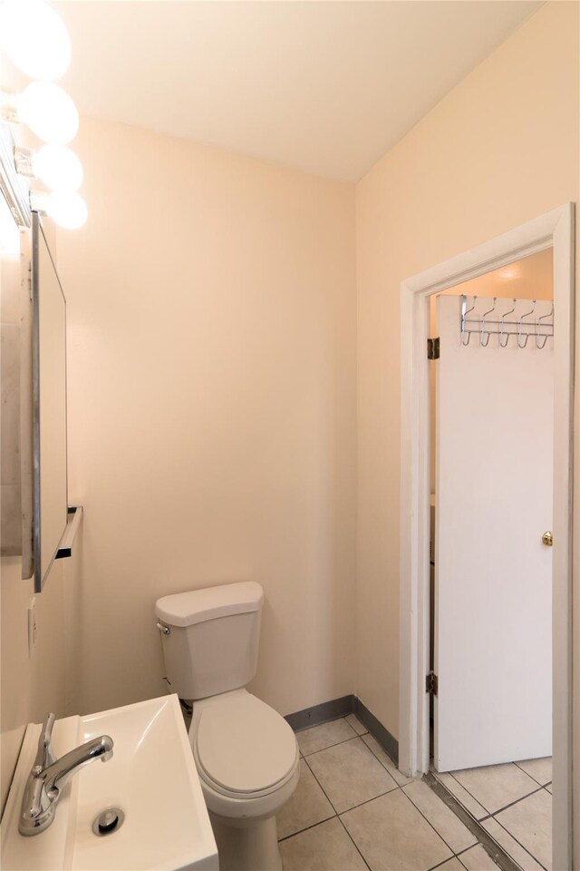10634 Sutphin Blvd, Jamaica, NY 11435 - half bath with a sink, toilet, and tile patterned flooring