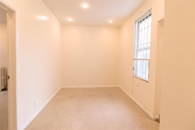 10634 Sutphin Blvd, Jamaica, NY 11435 - unfurnished room featuring light carpet, radiator, baseboards, and recessed lighting