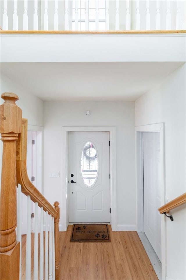 entrance foyer featuring stairs and wood finished floors