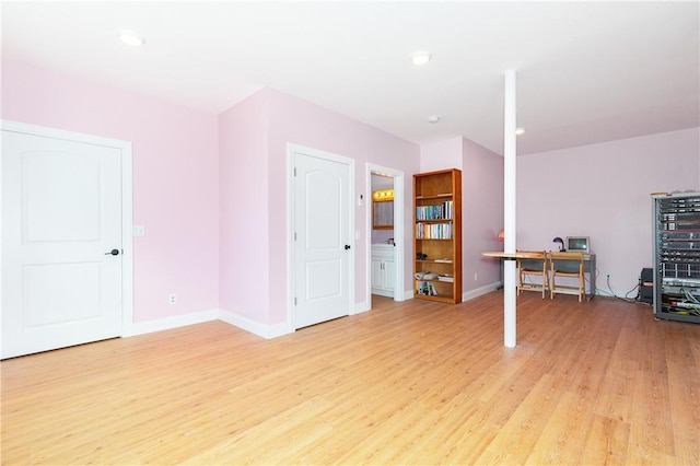 interior space featuring light wood-type flooring and baseboards