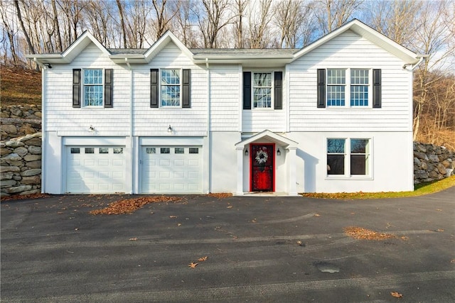 view of front of property with an attached garage and aphalt driveway