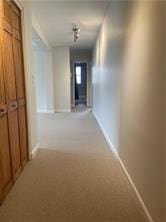 hallway featuring baseboards