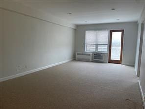 spare room featuring carpet flooring and baseboards